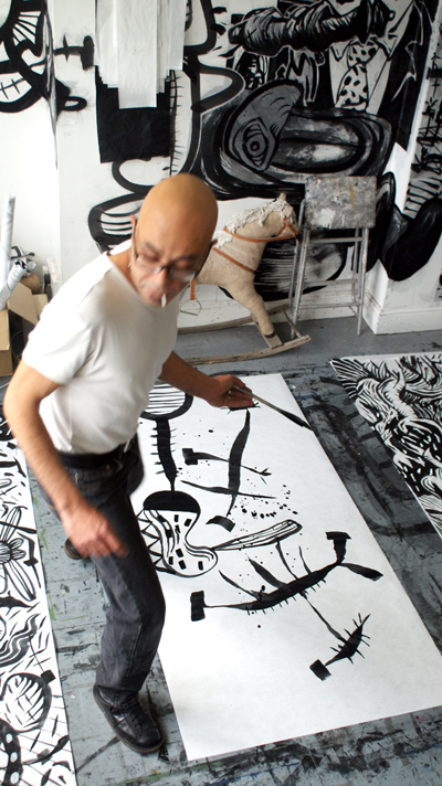 nazir tanbouli at work drawing in the studio